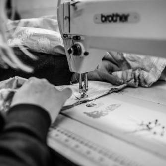 Seamstress using a sewing machine